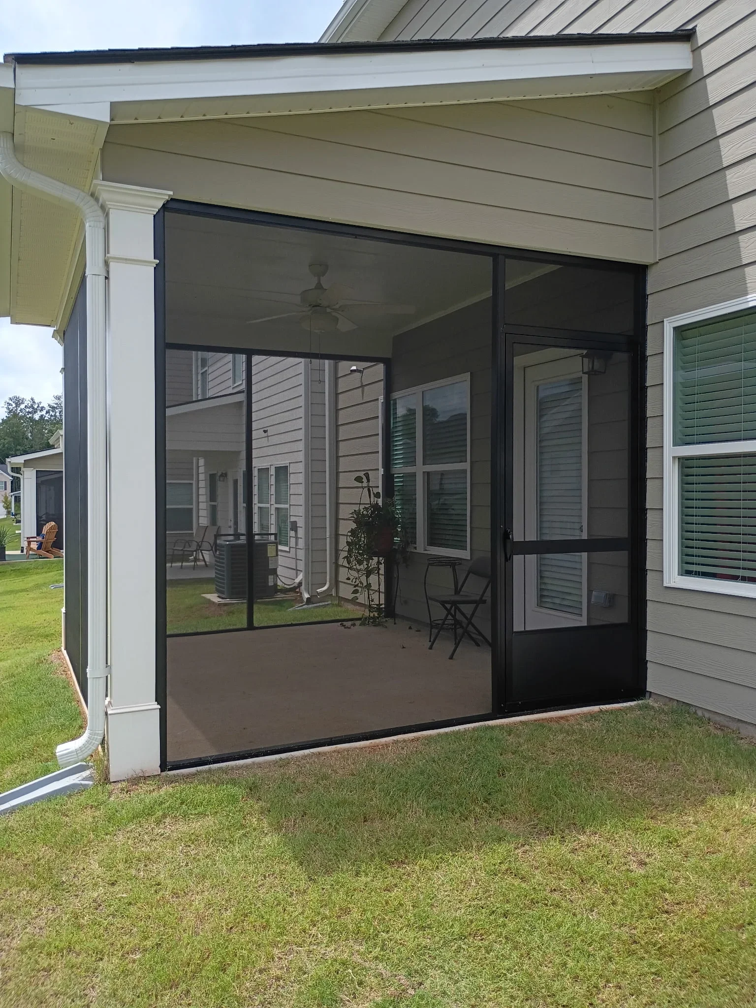 Installed aluminum screen room attached to residential home patio