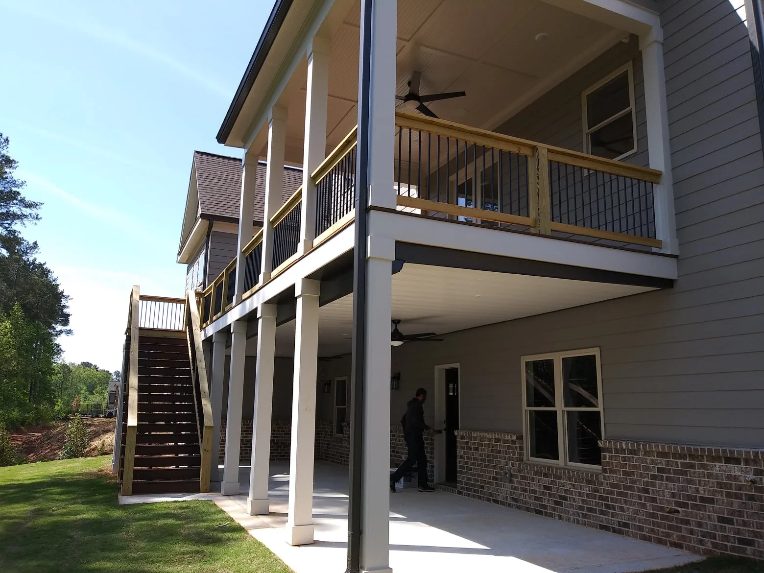 Custom under deck system installed beneath elevated wooden deck with weatherproof ceiling