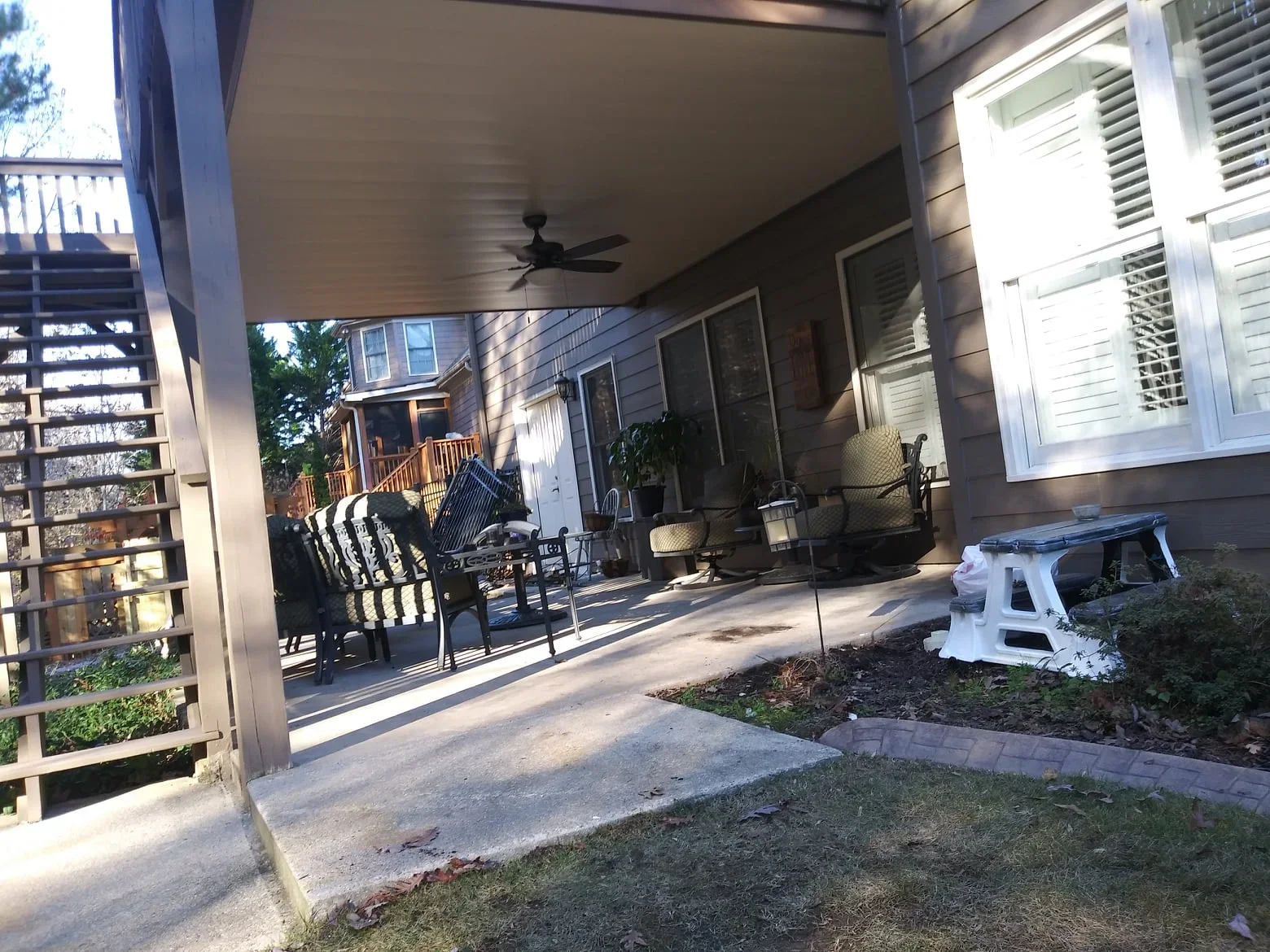 Under-deck aluminum ceiling system with fan and lighting installed beneath elevated deck