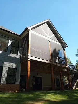 Two-story screen room with covered patio attached to residential home