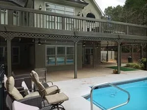 Covered patio with screen room addition overlooking backyard pool area