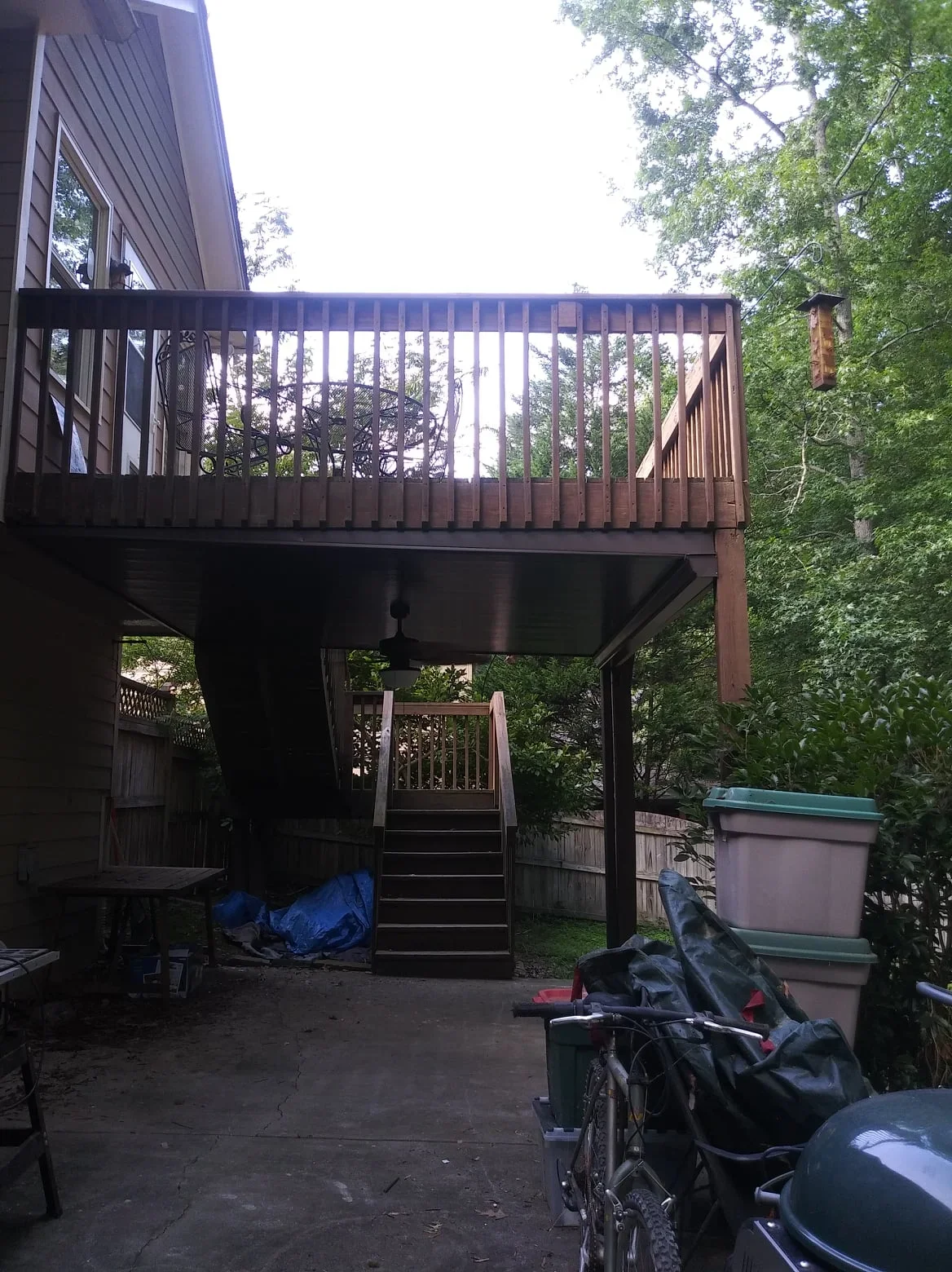 Two-tier deck with under-deck system and upper-level screened room enclosure