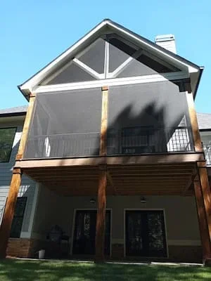 Two-story screen room with gable roof and full screening on upper deck