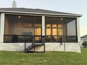 Modern screen room with glass doors and metal frame on residential home