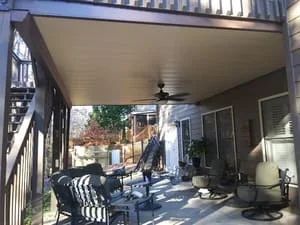 Covered screen room with aluminum patio roof, ceiling fan, and framed screens